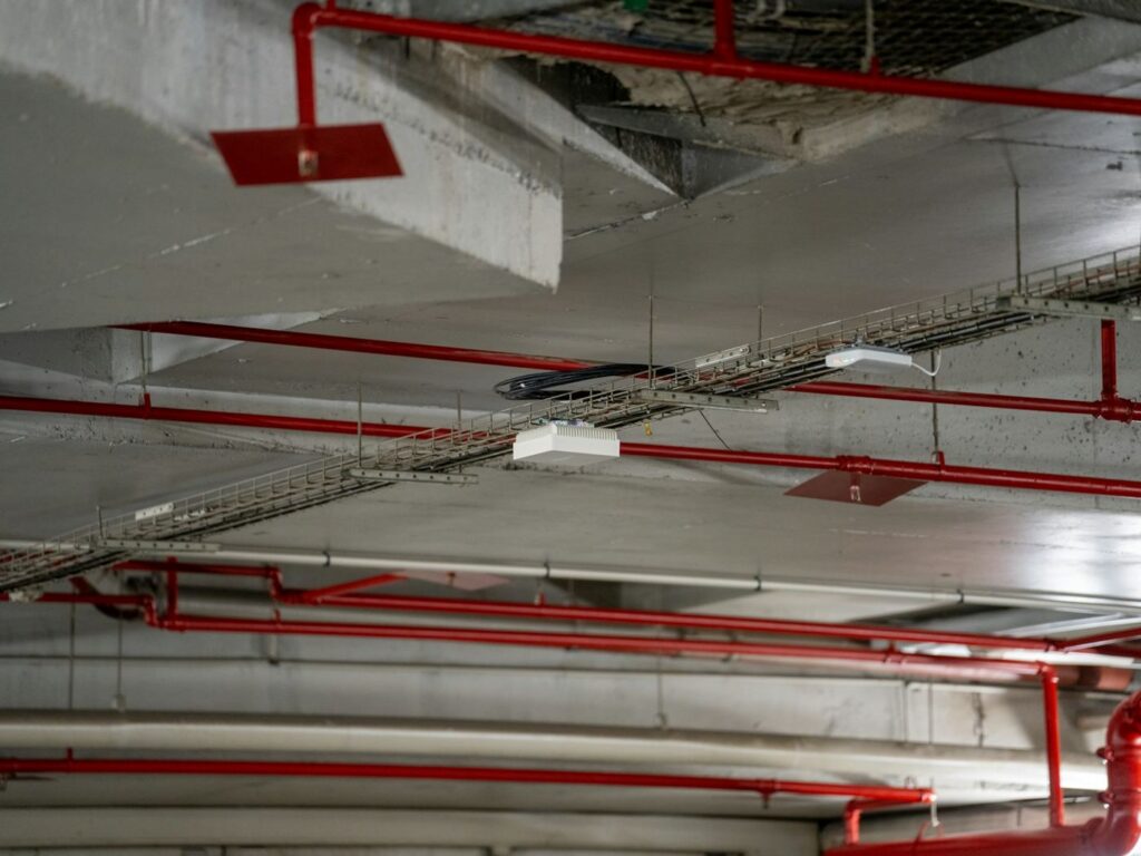 Fire sprinkler mains and cable trays at ceiling level